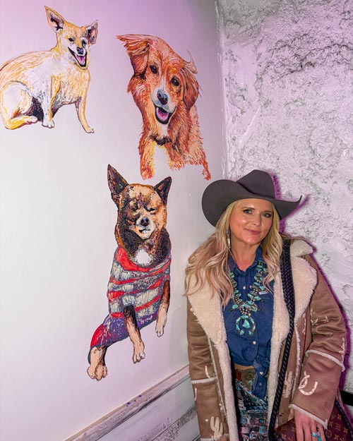Miranda with portraits of her dogs in MuttNation Alley.